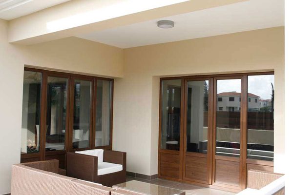 Woodgrain uPVC balcony doors opening onto a covered terrace