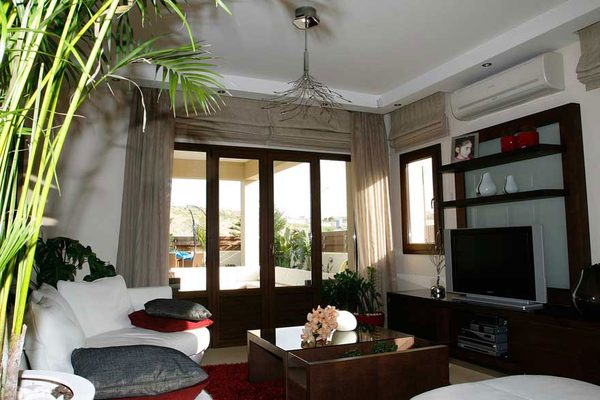 Corner living room with woodgrain window frames and glazed doors