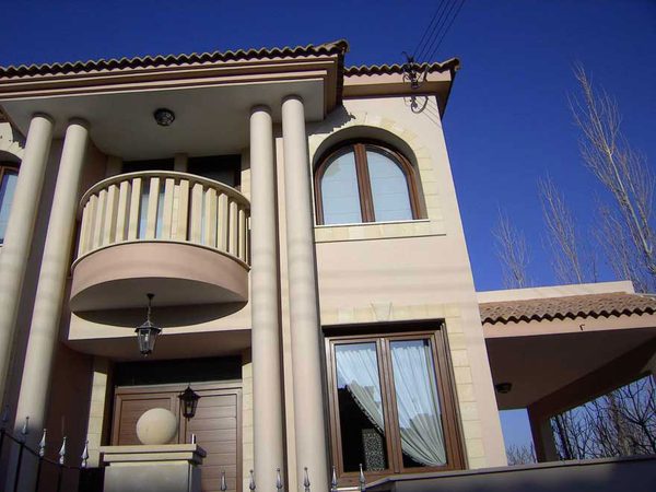 Colonnaded house front with arched and rectangular windows