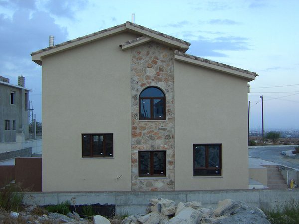 Two-storey house with arched and rectangular woodgrain windows