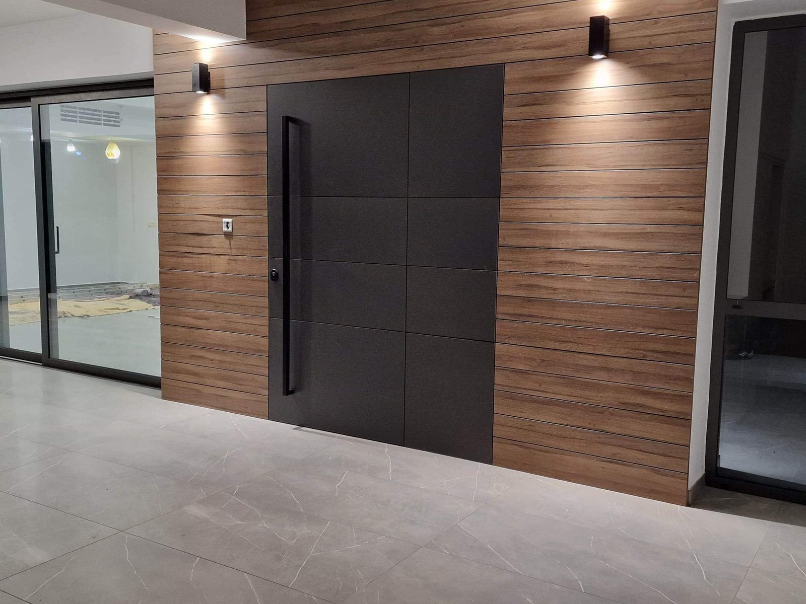 Pivot door set into timber cladding