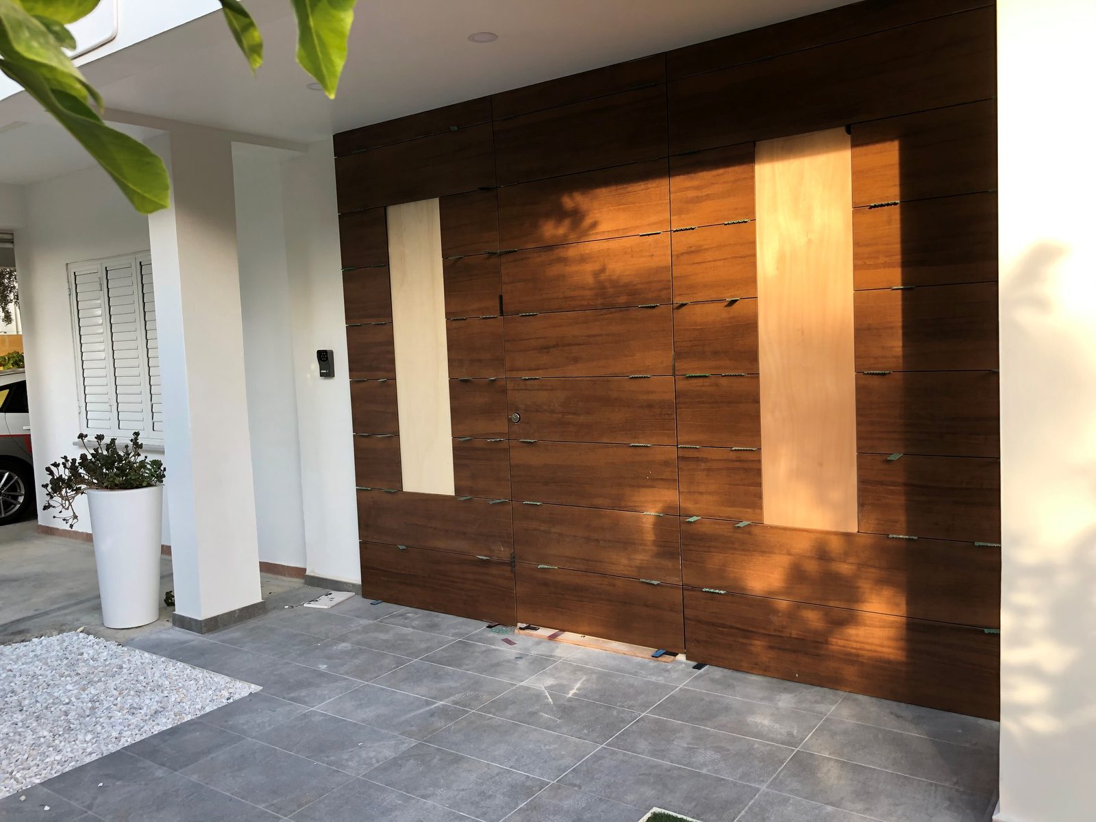 Armoured door merged into full timber wall cladding