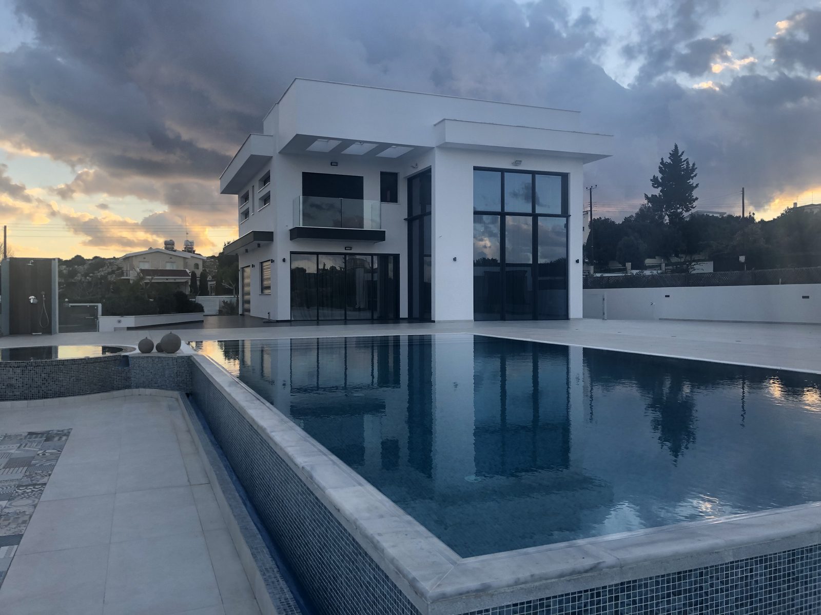 Full-height glazing on a poolside elevation