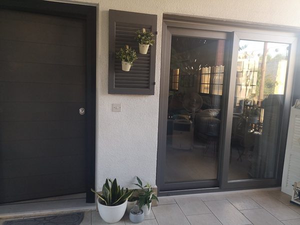 Dark aluminium sliding doors to the garden